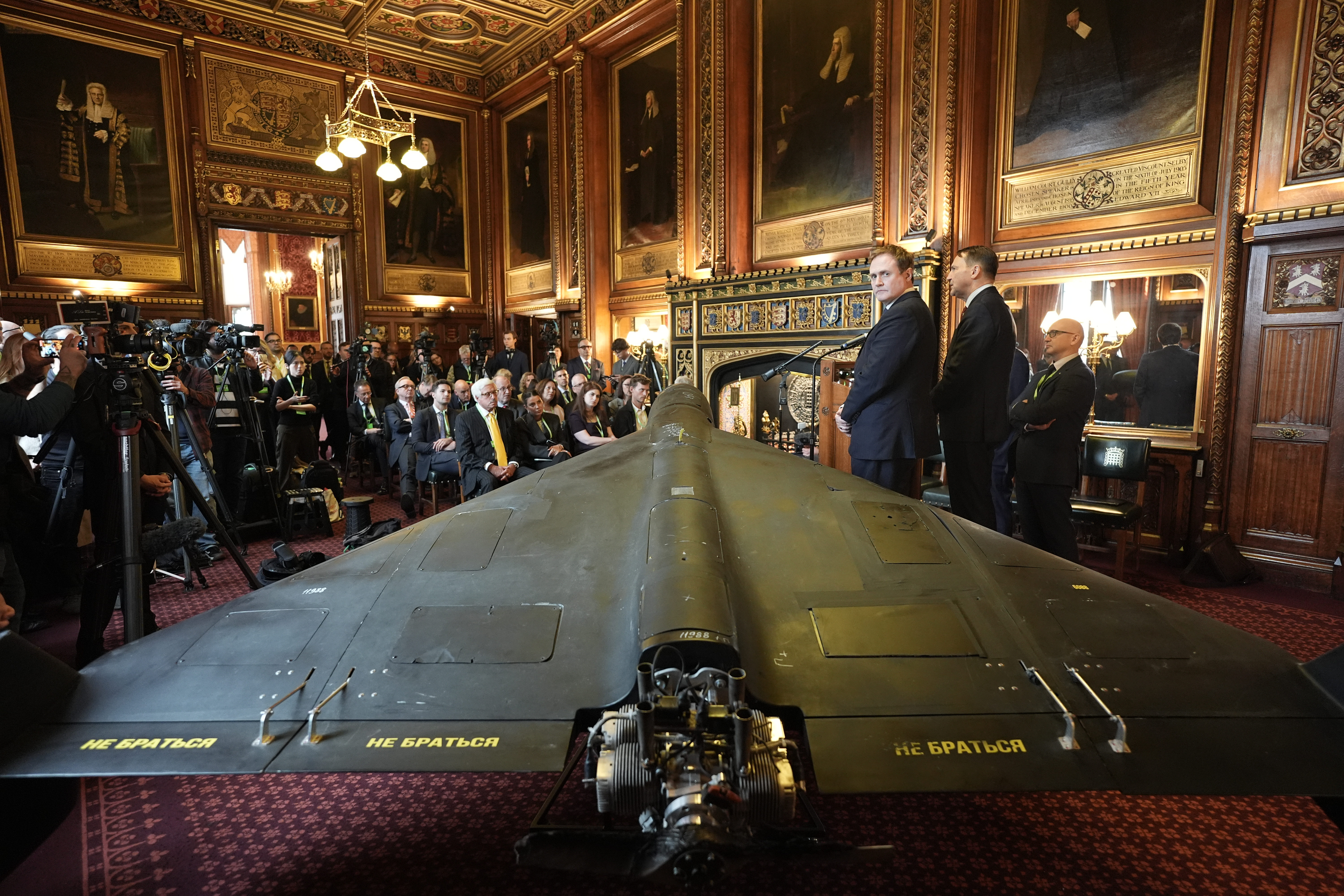 Former security minister Tom Tugendhat (third right) and Polish foreign minister Radek Sikorski (second right), address attendees in front of a downed Iranian-made Shahed-136 attack drone, the type used by Vladimir Putin's forces, during a press conference organised by United Against Nuclear Iran (UANI), in Speaker's Court at the House of Commons, Westminster. Picture date: Tuesday October 14, 2025. (Photo by Stefan Rousseau/PA Images via Getty Images)
